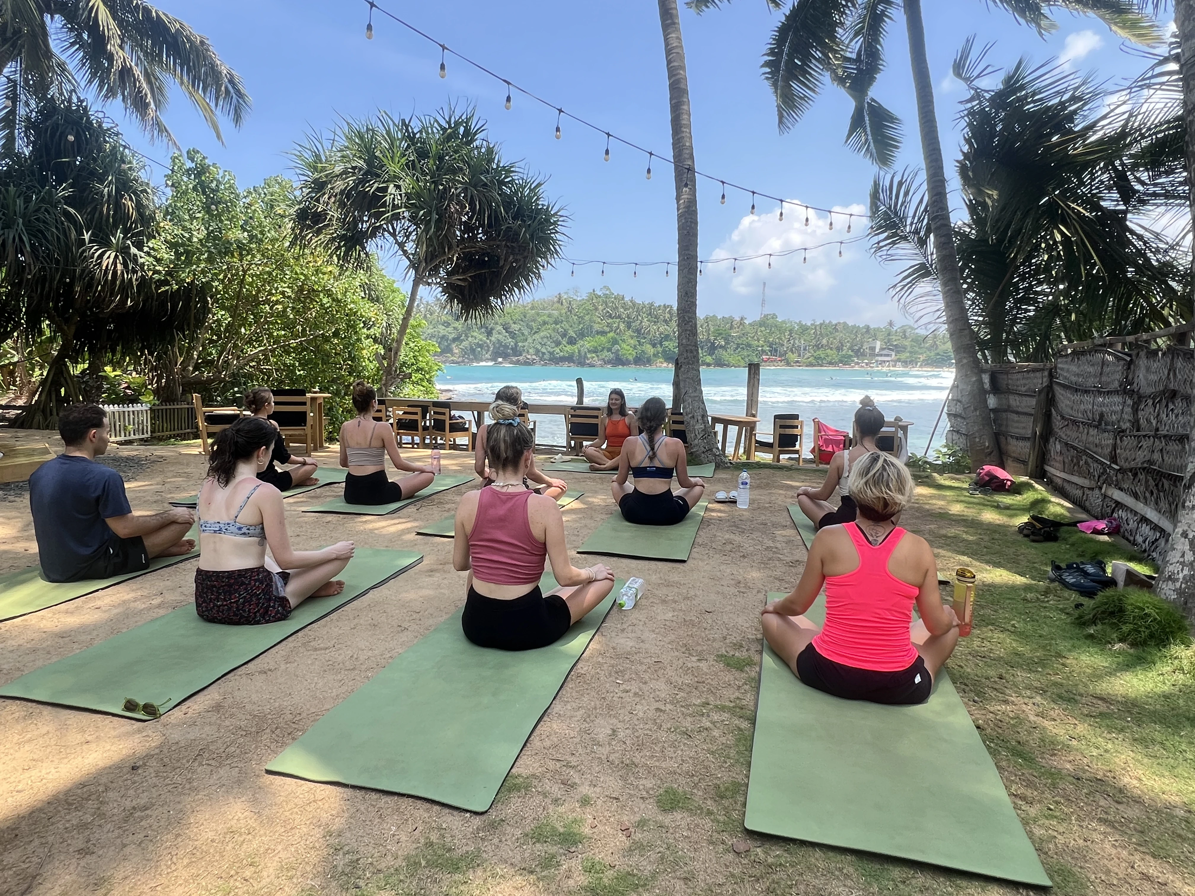 Csoportos jógaóra naplementében